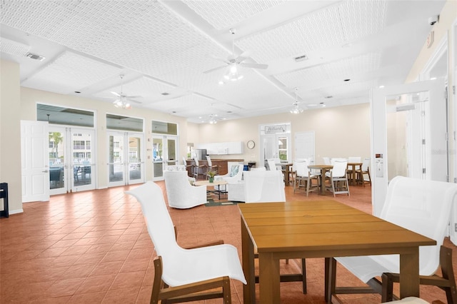 tiled dining room with french doors and ceiling fan