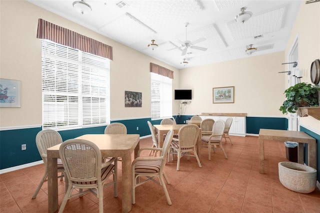 tiled dining area featuring ceiling fan