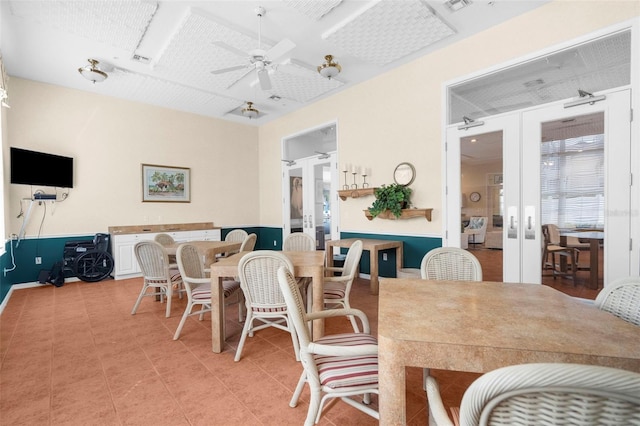 dining space featuring french doors and ceiling fan