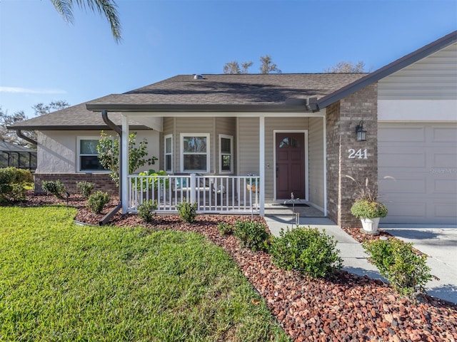 ranch-style house with a front yard, covered porch, and a garage