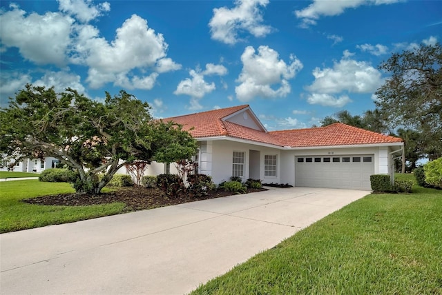 mediterranean / spanish-style house featuring a front lawn and a garage