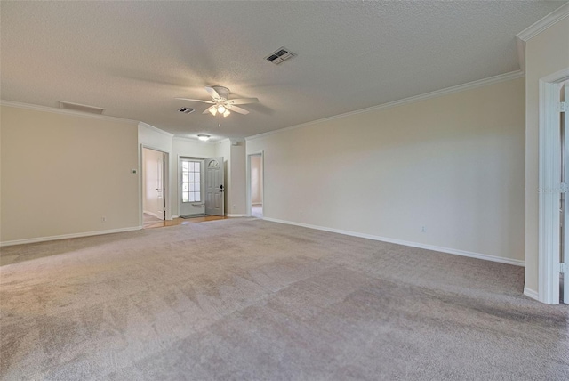 unfurnished room featuring a textured ceiling, light colored carpet, and ornamental molding