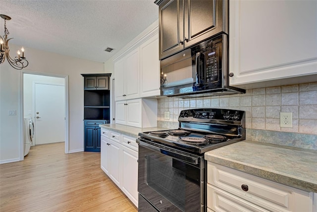 kitchen featuring decorative backsplash, light wood-type flooring, a textured ceiling, black appliances, and washer / dryer