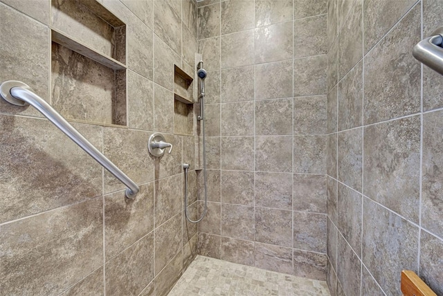 bathroom with a tile shower