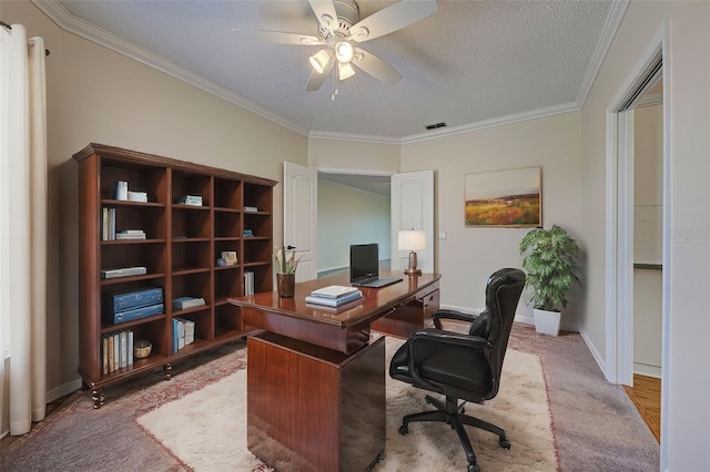 office space featuring ceiling fan, crown molding, light carpet, and a textured ceiling