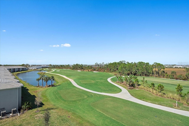 view of property's community with a water view and a lawn