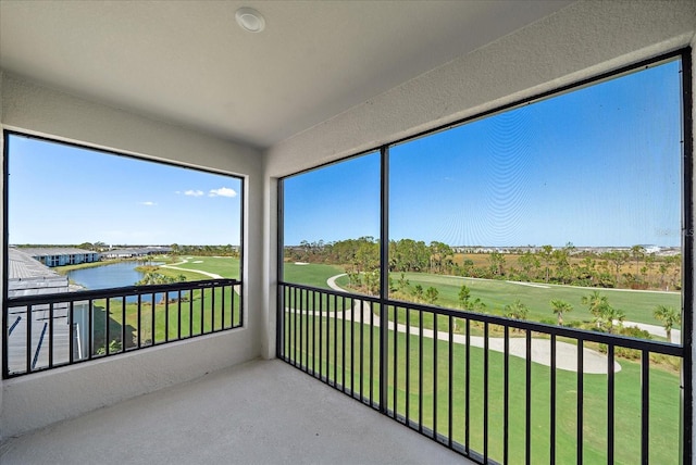 unfurnished sunroom featuring a water view