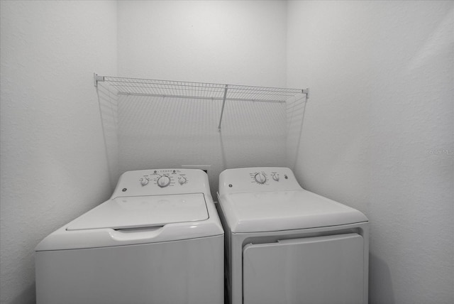 clothes washing area featuring washer and dryer