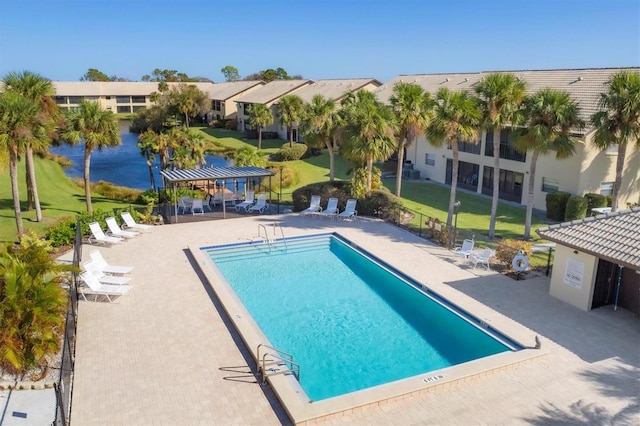 view of swimming pool with a patio area and a yard