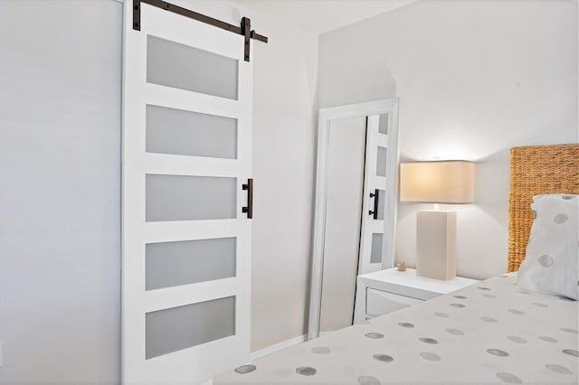 unfurnished bedroom featuring a barn door