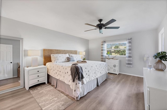 bedroom with light hardwood / wood-style floors and ceiling fan