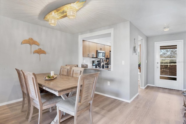 dining space featuring light wood-type flooring