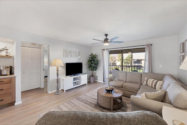 living room with ceiling fan and light wood-type flooring