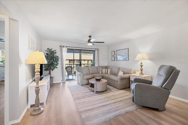 living room featuring light hardwood / wood-style flooring and ceiling fan