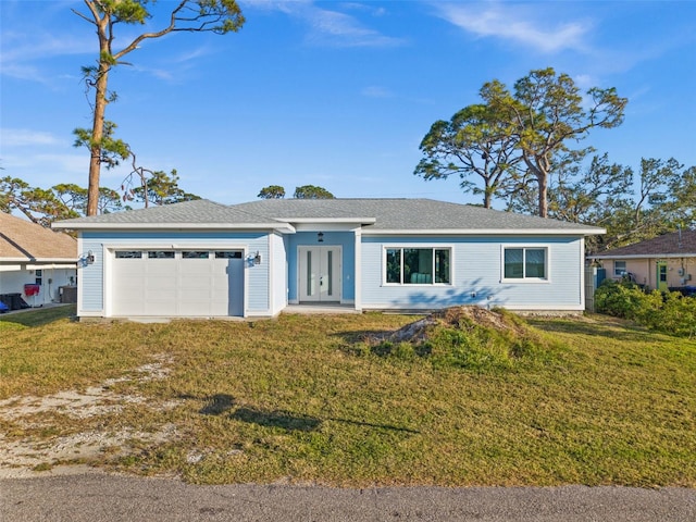 single story home featuring a garage and a front lawn