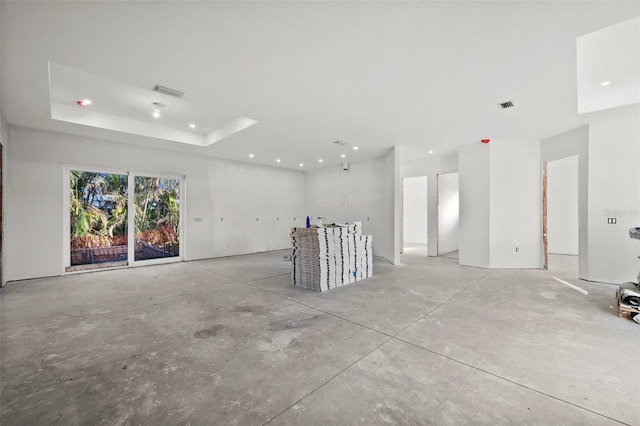 unfurnished room with a raised ceiling