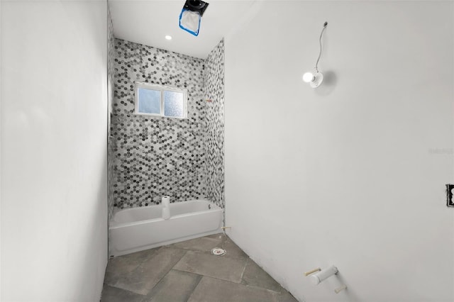 bathroom with tile patterned floors and tiled shower / bath combo