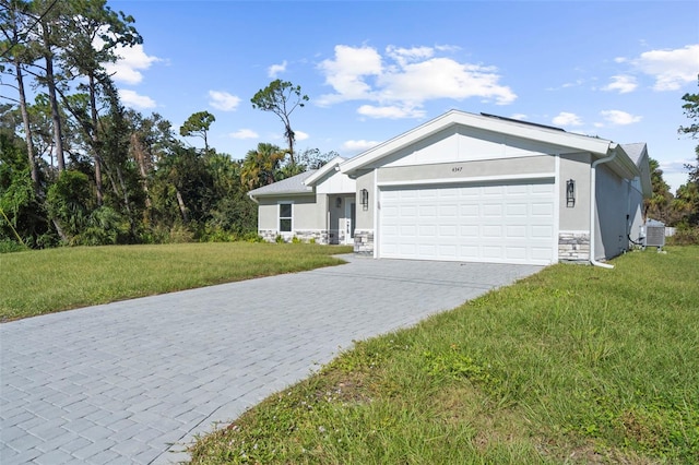 view of front facade featuring central AC, a front lawn, and a garage