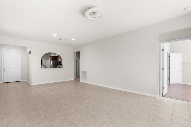 unfurnished living room with light tile patterned flooring