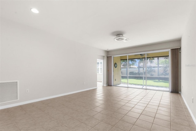 spare room featuring light tile patterned floors