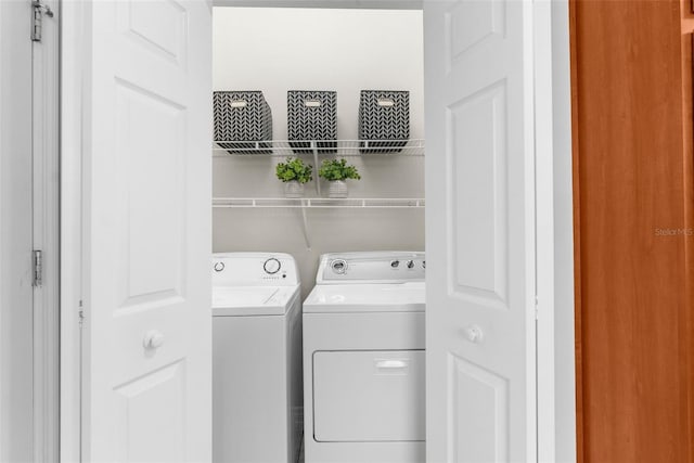 washroom featuring washing machine and dryer