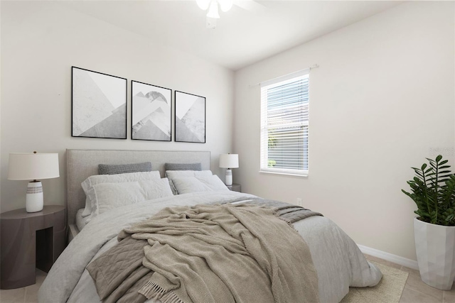 bedroom with ceiling fan and light tile patterned floors