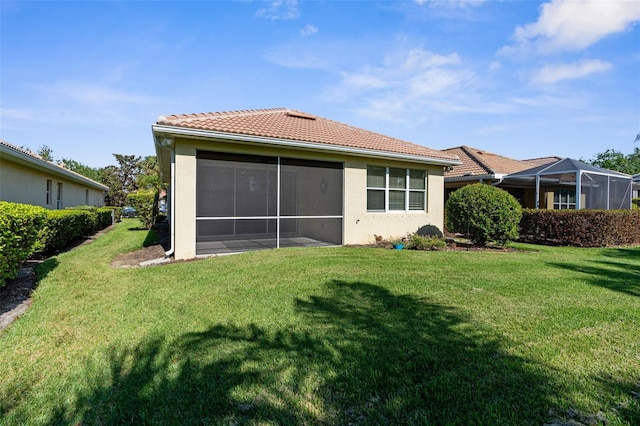 rear view of property with a lawn