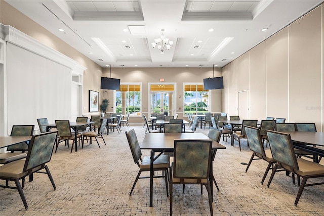 dining space featuring a high ceiling, crown molding, and an inviting chandelier