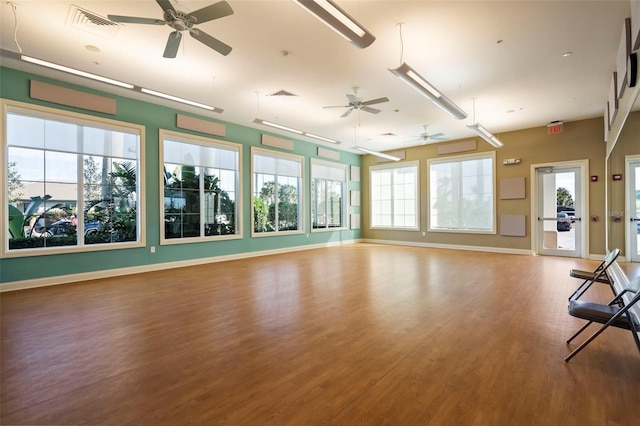 unfurnished living room featuring wood-type flooring and a healthy amount of sunlight