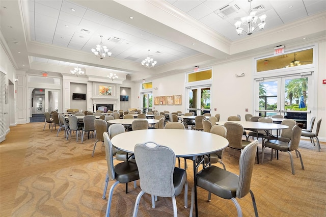 carpeted dining area featuring an inviting chandelier, crown molding, and french doors