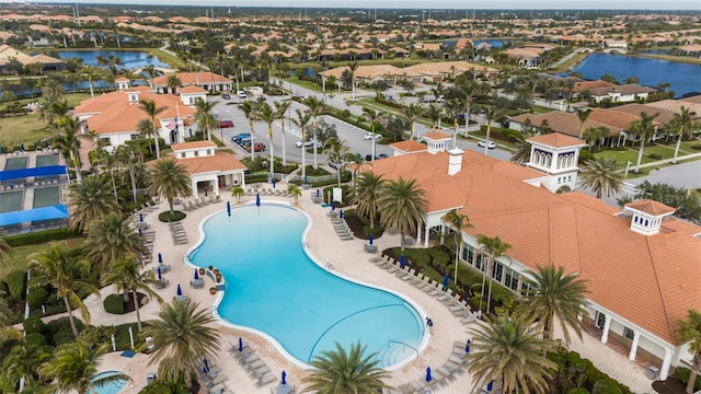 view of pool with a water view and a patio area