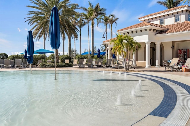 view of pool with pool water feature and a patio