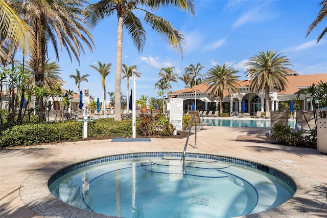 view of pool with a patio area and a community hot tub