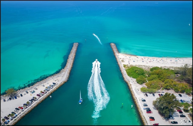 drone / aerial view with a beach view and a water view