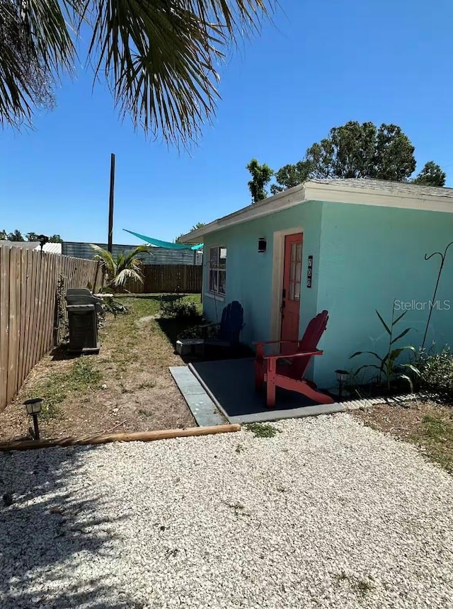 view of storm shelter with a patio