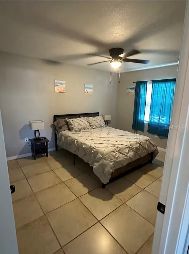 tiled bedroom with ceiling fan