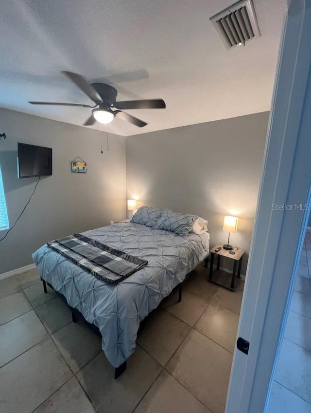 tiled bedroom with ceiling fan