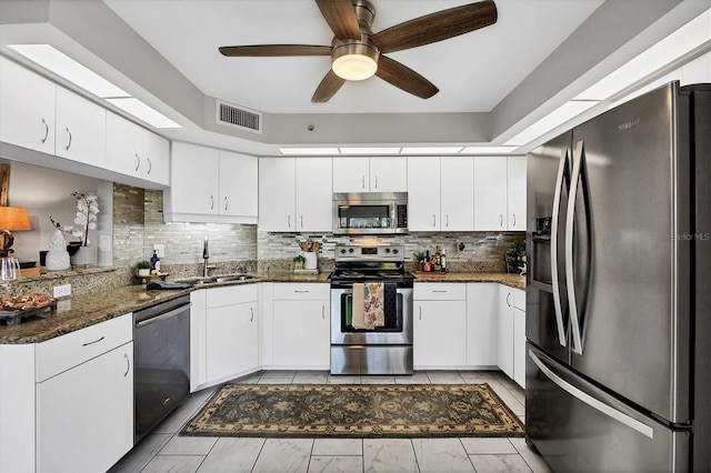 kitchen featuring white cabinets, stainless steel appliances, ceiling fan, and sink