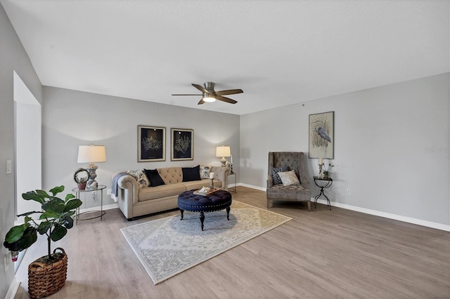 living room with wood-type flooring and ceiling fan