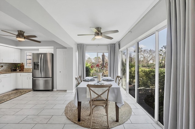 interior space featuring ceiling fan and plenty of natural light