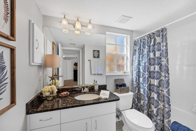 bathroom with vanity, a textured ceiling, and toilet