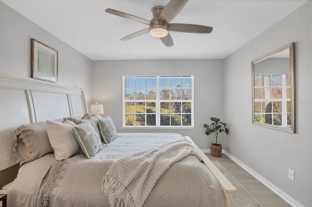 bedroom with ceiling fan and light hardwood / wood-style flooring