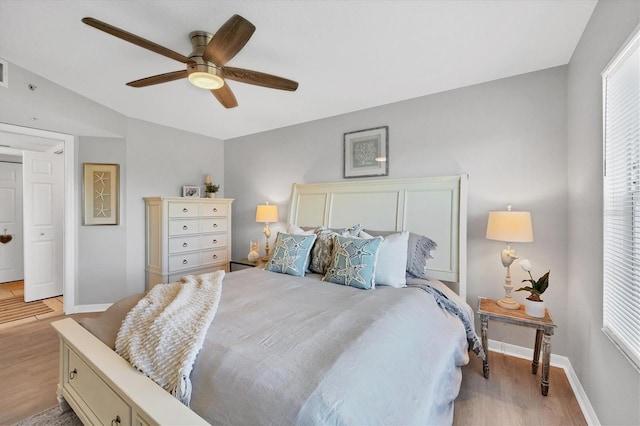 bedroom with ceiling fan and light hardwood / wood-style floors