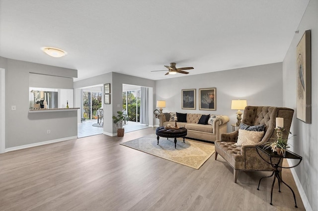 living room featuring hardwood / wood-style flooring and ceiling fan