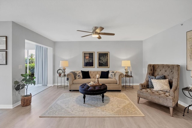 living room with light hardwood / wood-style floors and ceiling fan