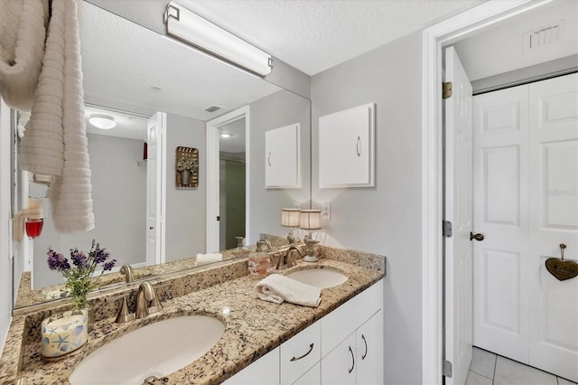 bathroom featuring vanity and a textured ceiling