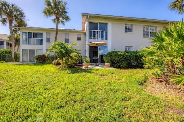 rear view of property with a lawn