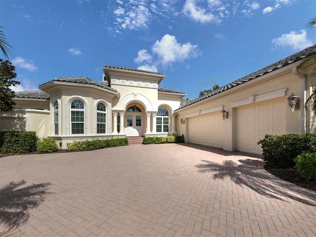 mediterranean / spanish-style house featuring a garage