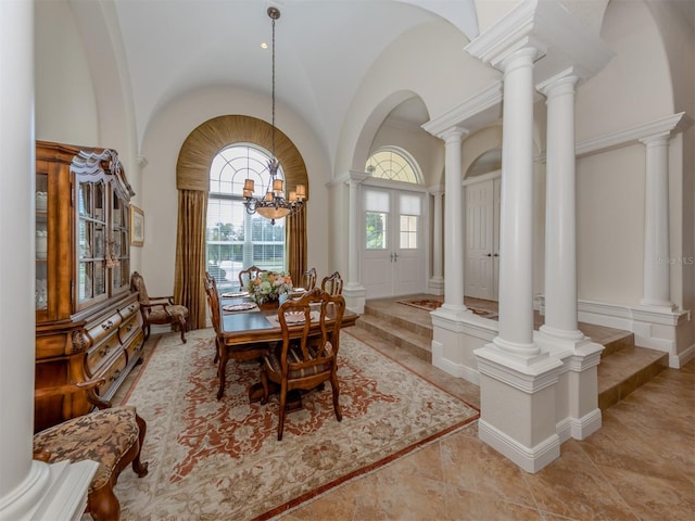 dining room featuring french doors, high vaulted ceiling, and a chandelier