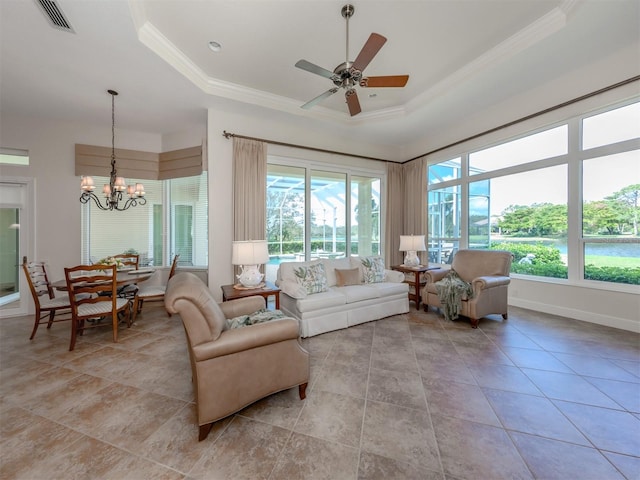 sunroom / solarium featuring ceiling fan with notable chandelier and a raised ceiling